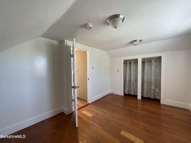 395 Laurel St, Lee, MA 01238 - unfurnished bedroom featuring hardwood / wood-style flooring, vaulted ceiling, baseboards, and multiple closets