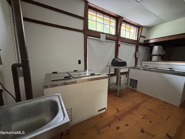 395 Laurel St, Lee, MA 01238 - kitchen with a sink, wood finished floors, a paneled ceiling, and fridge