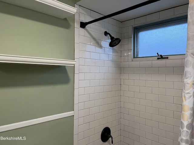 bathroom with tiled shower