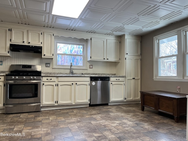 kitchen featuring appliances with stainless steel finishes, an ornate ceiling, a sink, and under cabinet range hood