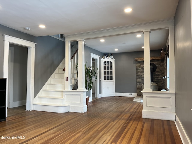 stairway with recessed lighting, wood finished floors, and baseboards