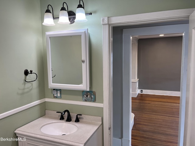 bathroom with wood finished floors and vanity