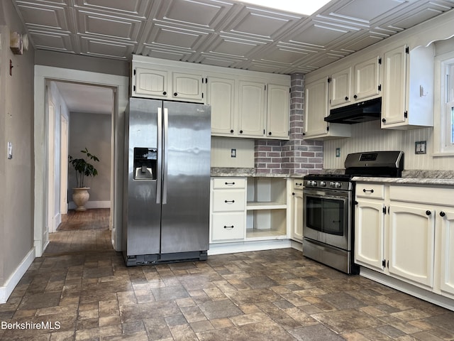 kitchen featuring light stone counters, an ornate ceiling, appliances with stainless steel finishes, under cabinet range hood, and baseboards