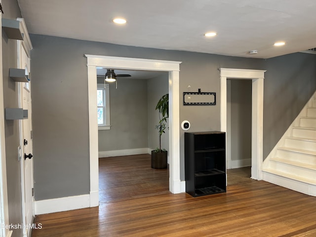 interior space with recessed lighting, wood finished floors, a ceiling fan, baseboards, and stairway