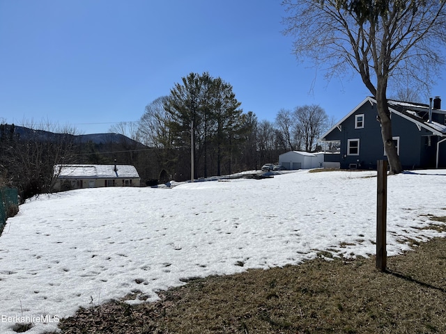 yard covered in snow featuring an outdoor structure