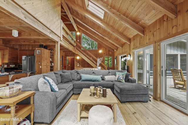 112 Silver St, Lanesborough, MA 01237 - living room featuring wooden walls, light wood-type flooring, wood ceiling, and a skylight