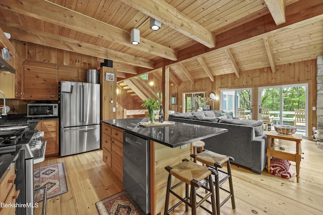 112 Silver St, Lanesborough, MA 01237 - kitchen featuring stainless steel appliances, wood walls, wood ceiling, light wood-style flooring, and a kitchen breakfast bar