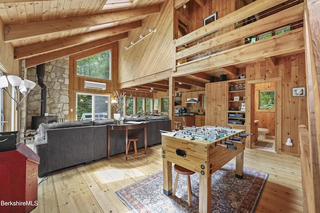 112 Silver St, Lanesborough, MA 01237 - recreation room with high vaulted ceiling, light wood finished floors, a wood stove, wood walls, and a wood ceiling with exposed beams