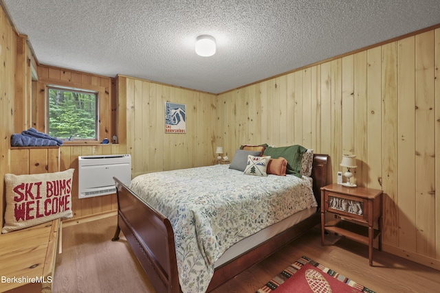 112 Silver St, Lanesborough, MA 01237 - bedroom with wood finished floors, heating unit, a textured ceiling, wood walls, and crown molding