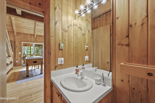 112 Silver St, Lanesborough, MA 01237 - bathroom with wood walls, a wood ceiling with exposed beams, vanity, and wood finished floors