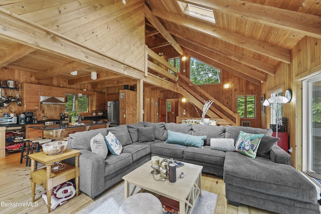 112 Silver St, Lanesborough, MA 01237 - living room featuring wood walls, light wood-style flooring, wood ceiling, and a skylight