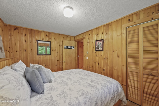 112 Silver St, Lanesborough, MA 01237 - bedroom with a textured ceiling, wooden walls, and a closet