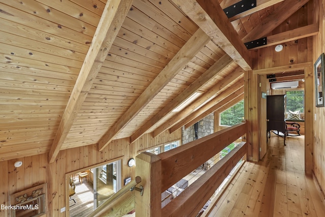 112 Silver St, Lanesborough, MA 01237 - detailed view of a wall mounted AC, a wooden ceiling with exposed beams, wood walls, and wood finished floors