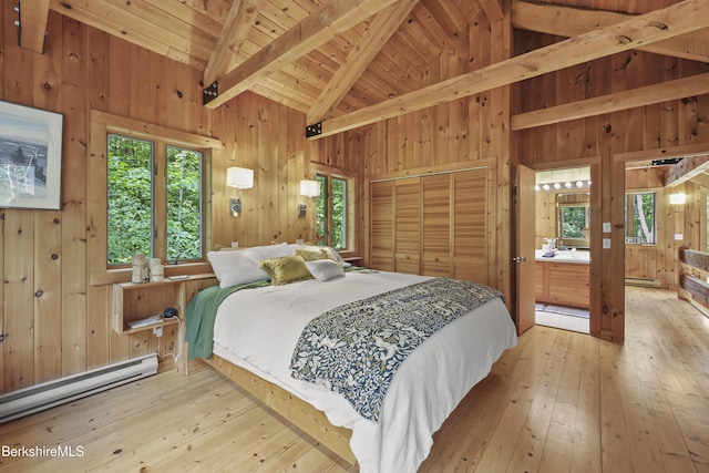 112 Silver St, Lanesborough, MA 01237 - bedroom featuring wood walls, wood-type flooring, a baseboard heating unit, wooden ceiling, and connected bathroom