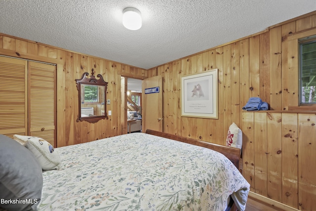 112 Silver St, Lanesborough, MA 01237 - bedroom with a textured ceiling, wood walls, a closet, and ornamental molding