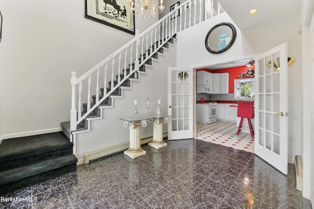 entrance foyer featuring marble finish floor, stairs, a high ceiling, french doors, and recessed lighting