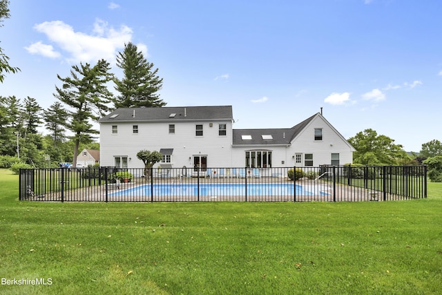 view of pool featuring a fenced in pool, fence, a lawn, and a patio