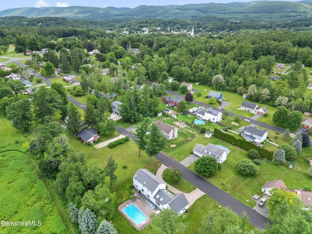 birds eye view of property featuring a forest view and a mountain view