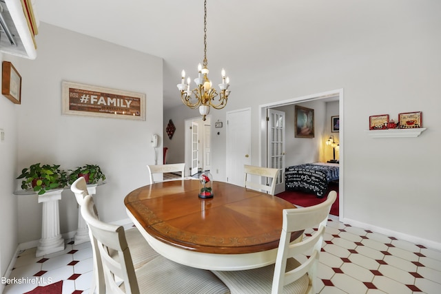 dining room featuring a chandelier, baseboards, and tile patterned floors