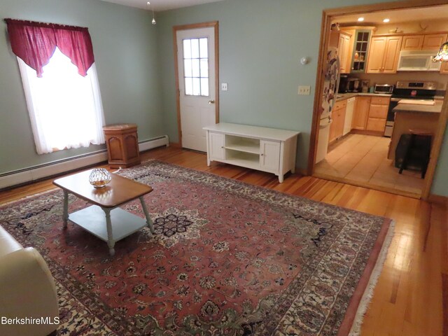 16-18 Hoosac St, Adams, MA 01220 - living room with light wood-style flooring and a baseboard radiator