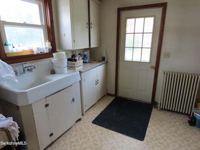 16-18 Hoosac St, Adams, MA 01220 - laundry room with radiator heating unit, healthy amount of natural light, light floors, and a sink
