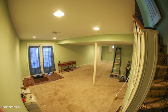 basement featuring carpet flooring and french doors