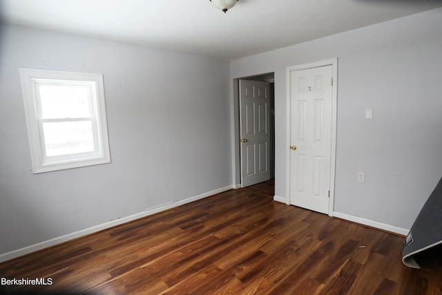 unfurnished room featuring dark hardwood / wood-style floors