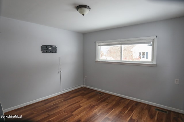 empty room featuring dark hardwood / wood-style floors