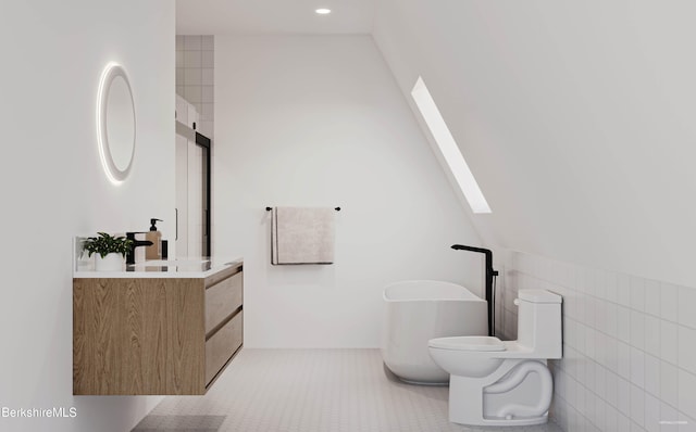 bathroom featuring tile patterned flooring, lofted ceiling, toilet, vanity, and tile walls