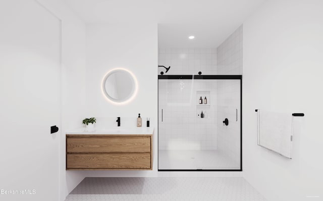 bathroom featuring tile patterned floors, a shower with door, and vanity