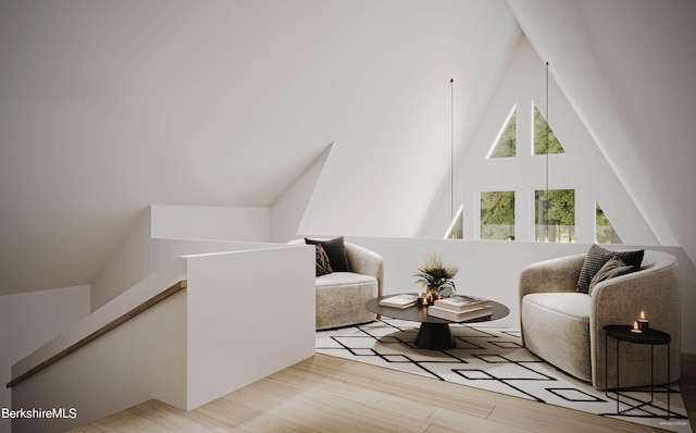 living area with vaulted ceiling and light hardwood / wood-style flooring