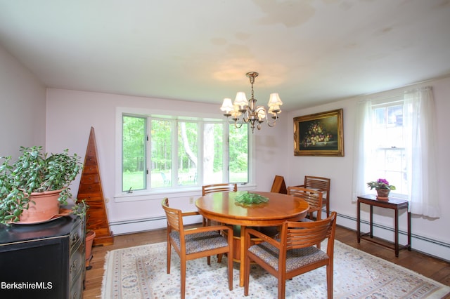 31 Oxbow Rd, Charlemont, MA 01339 - dining space featuring a baseboard heating unit, healthy amount of natural light, a chandelier, and light wood-style flooring