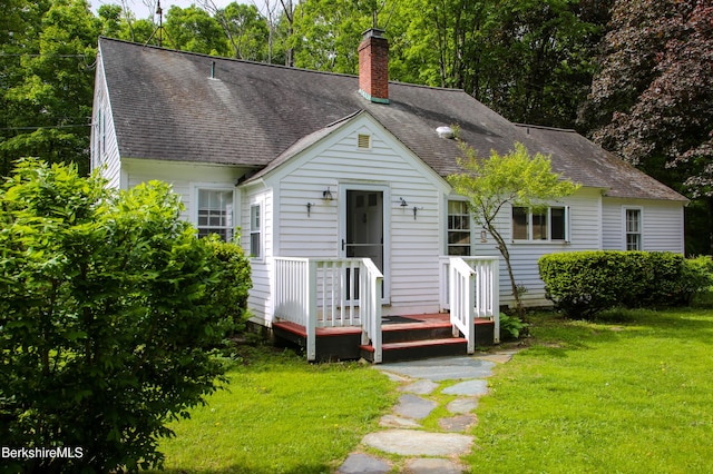 31 Oxbow Rd, Charlemont, MA 01339 - view of front of property featuring roof with shingles, a chimney, and a front yard