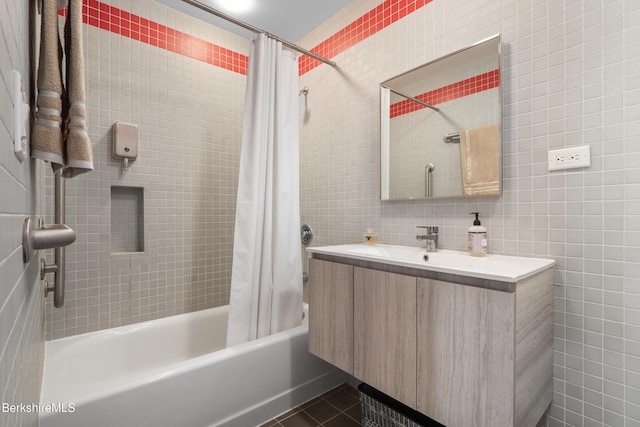 full bathroom featuring tile walls, shower / bath combo with shower curtain, vanity, and tile patterned floors