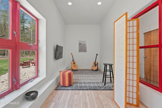 interior space with wood finished floors, recessed lighting, and baseboards