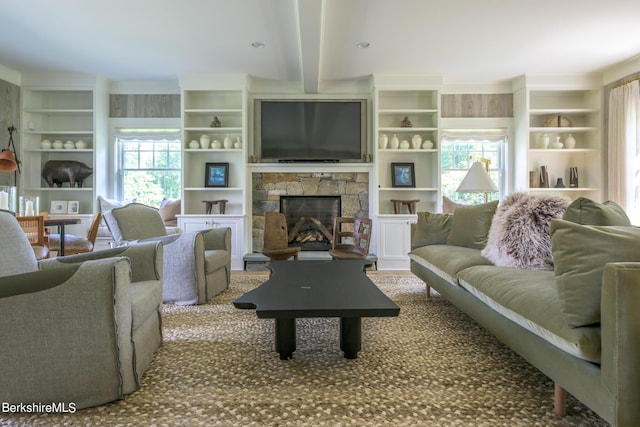 living room with a stone fireplace