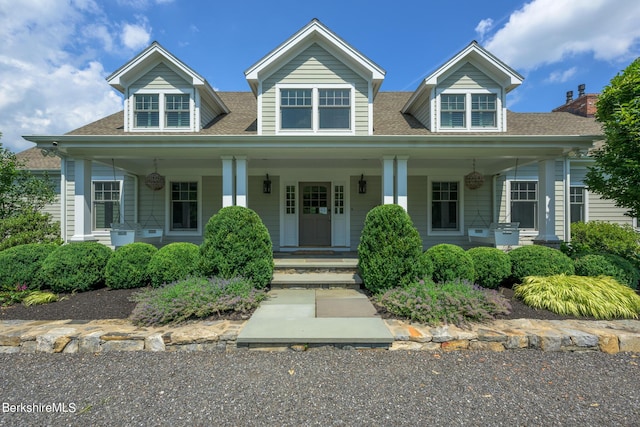 cape cod-style house featuring covered porch