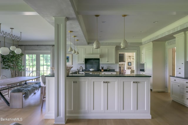 kitchen featuring decorative light fixtures, stainless steel gas cooktop, and light hardwood / wood-style floors