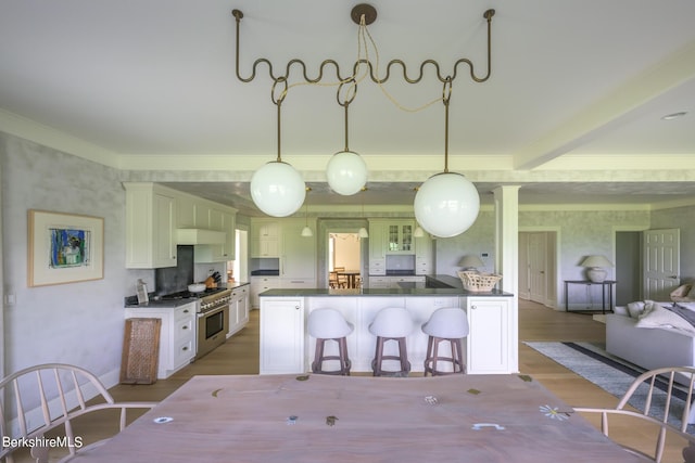 dining area with light hardwood / wood-style floors and ornamental molding