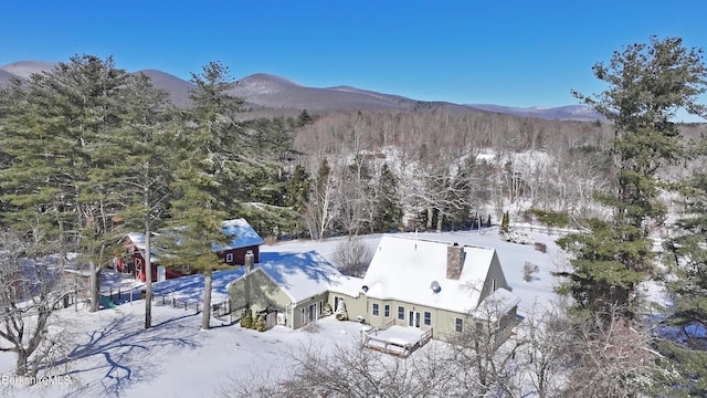 snowy aerial view featuring a mountain view