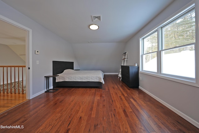 unfurnished bedroom with dark wood finished floors, visible vents, and baseboards