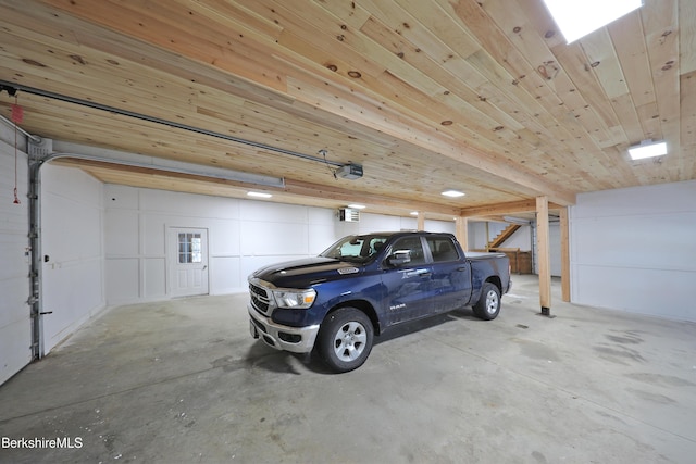 garage featuring wood ceiling and a garage door opener