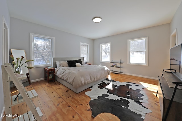 bedroom with light wood-style flooring and baseboards