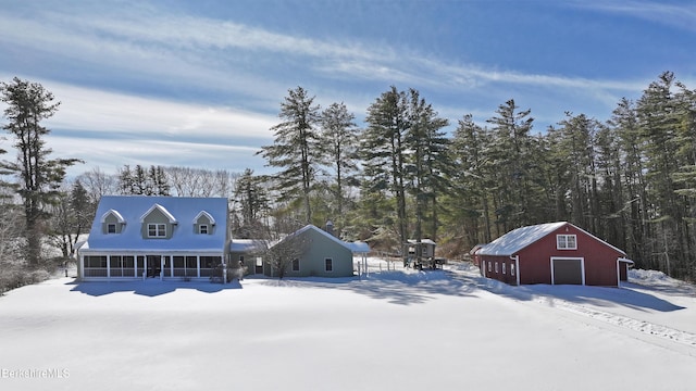 exterior space featuring a garage, an outbuilding, and a sunroom