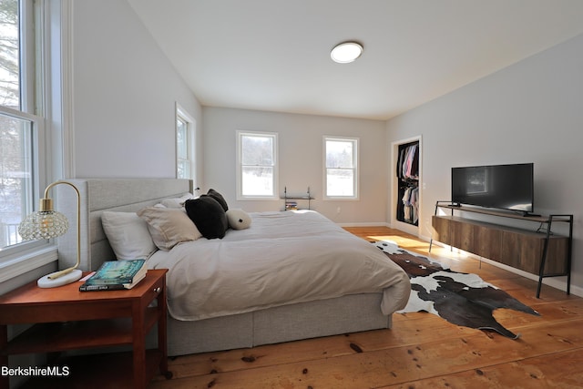 bedroom featuring baseboards and hardwood / wood-style floors