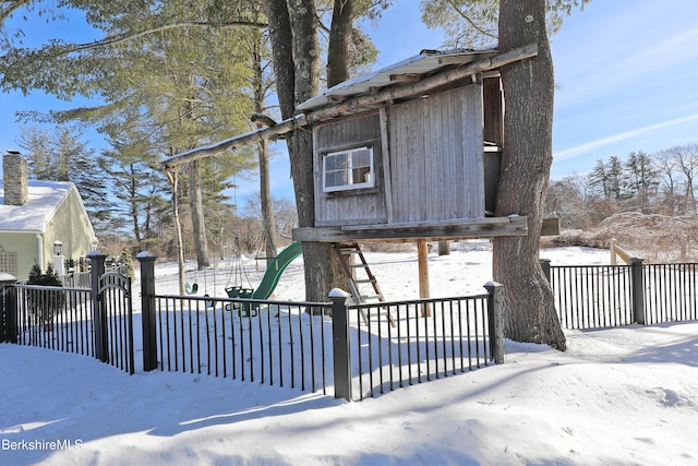 exterior space featuring a playground and fence