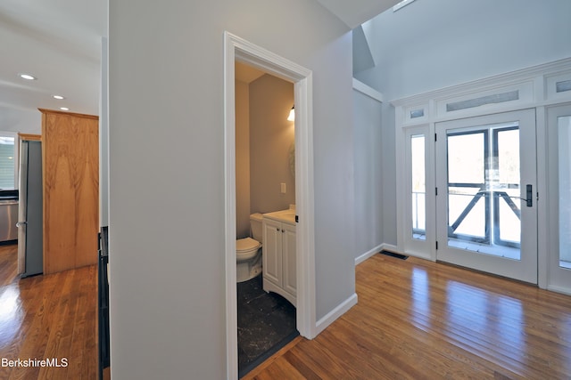 entrance foyer with baseboards, visible vents, wood finished floors, and recessed lighting