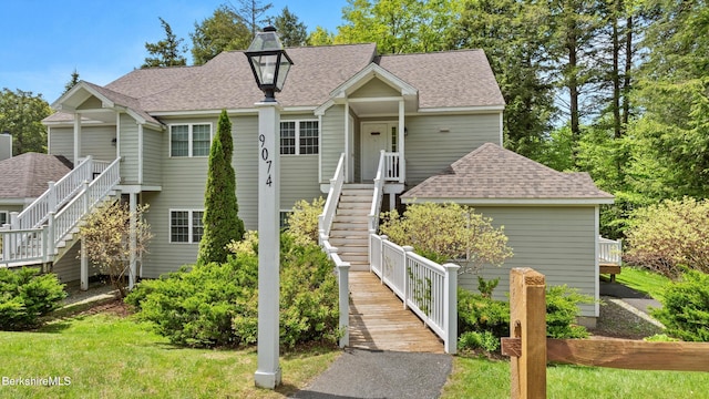 9074 Mountainside Dr, Hancock, MA 01237 - view of front of house featuring stairs, roof with shingles, and a chimney