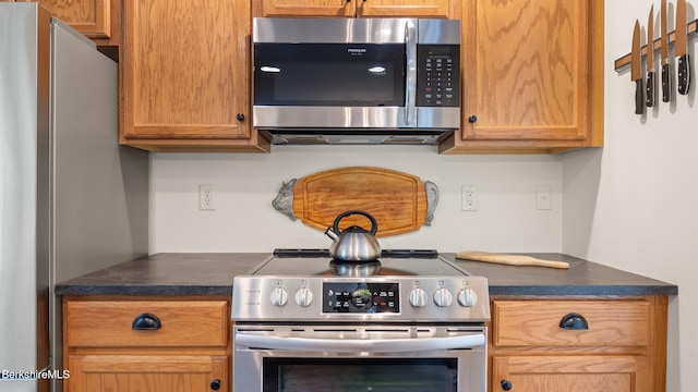 9074 Mountainside Dr, Hancock, MA 01237 - kitchen with appliances with stainless steel finishes and dark countertops