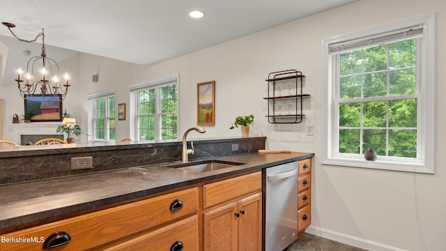 9074 Mountainside Dr, Hancock, MA 01237 - kitchen featuring a sink, dishwasher, a chandelier, baseboards, and brown cabinetry